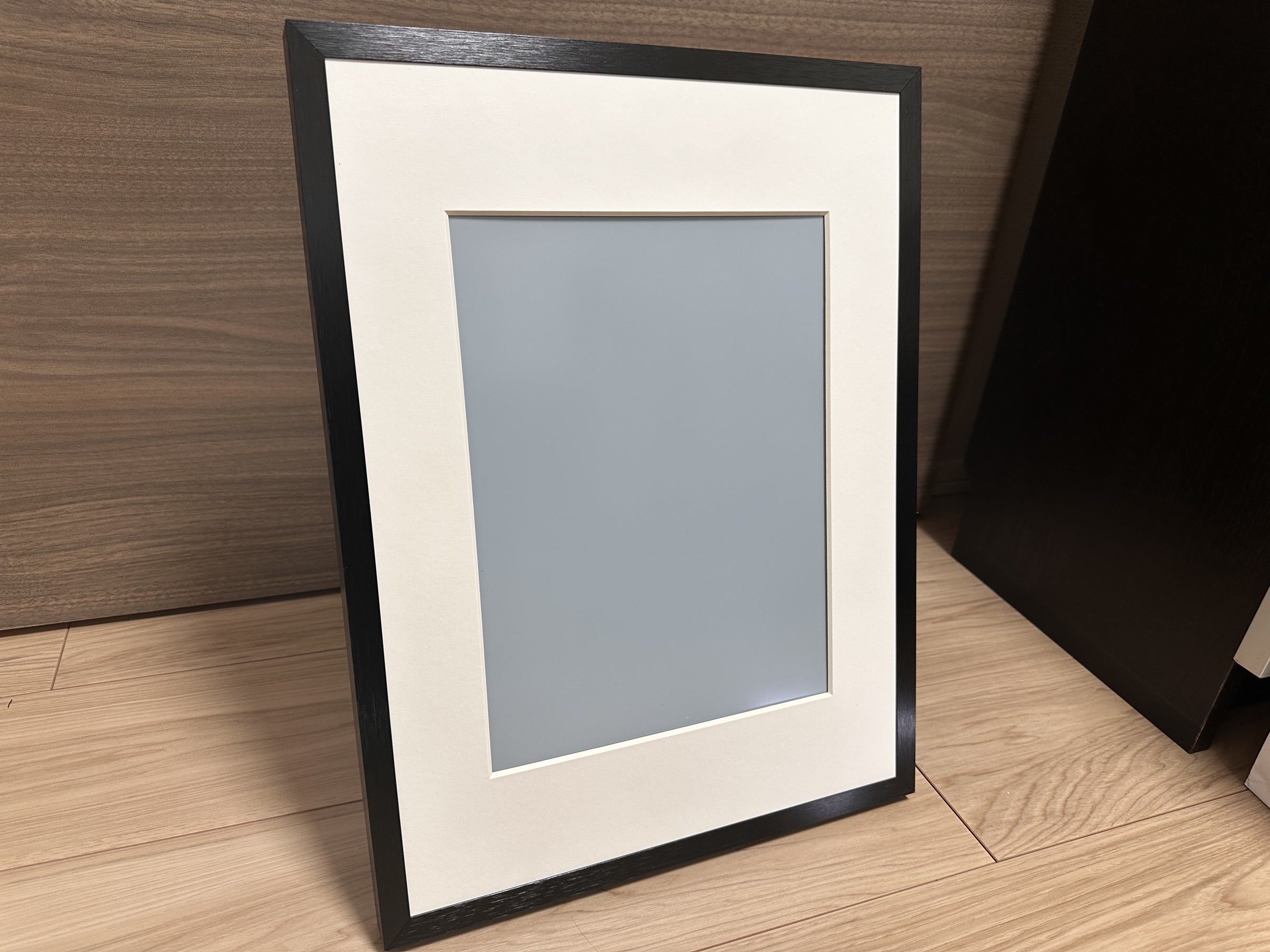 SwitchBot AIアートフレーム本体の前面。黒いフレームと白いマット付きで、電源オフ時でも一般的な額縁に近い見た目をしている